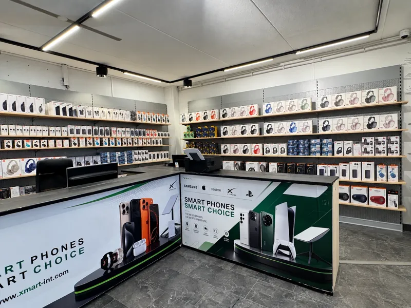 Shelves of headphones, speakers and smartwatches next to the counter